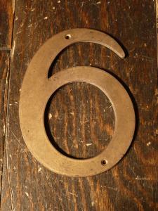 brass sign “6”