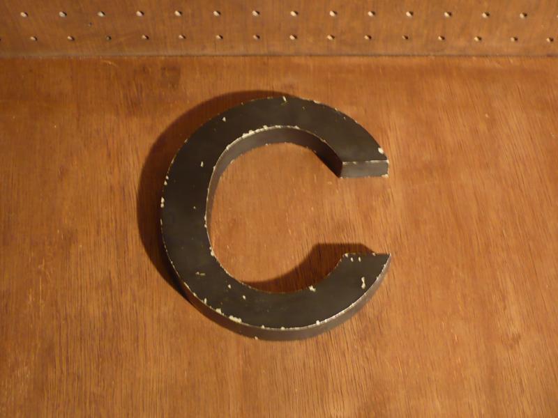 English black sign  “C”